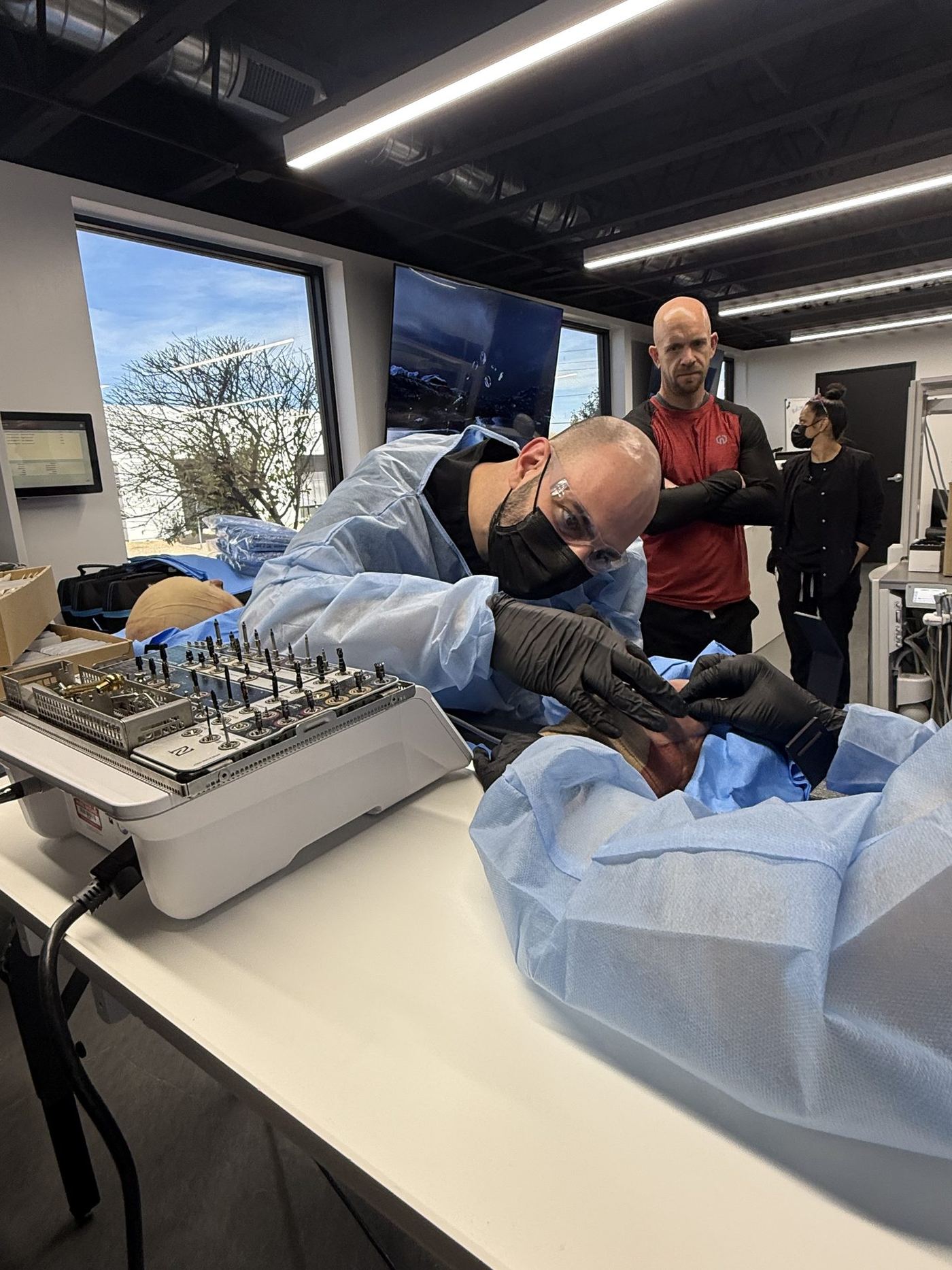 Dentists practicing implant placement on cadaver specimens during the Implant Progression track