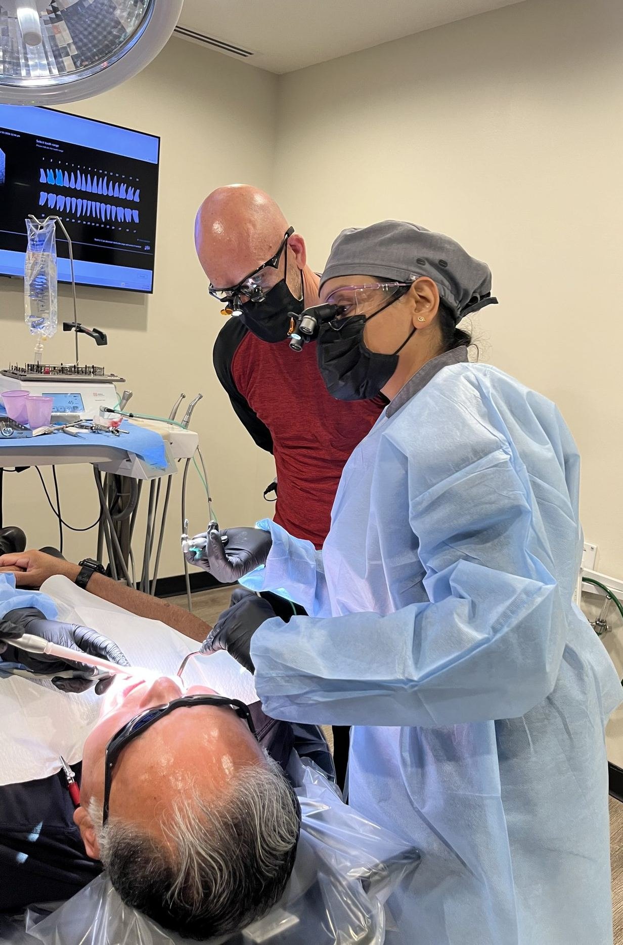 Dentist performing supervised live patient implant surgery at the Implant Education Company training center in Phoenix