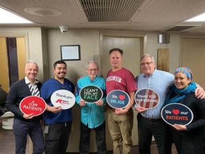 Training Dentists Holding Signs